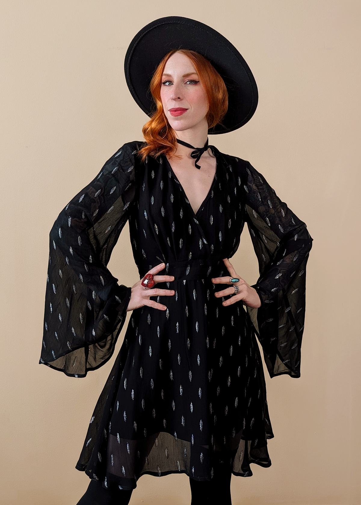 Stevie Nicks vibes. Witchy Angel Bell Sleeve Mini dress with v-neckline, and fluttery, floaty fit. Black colorway with silver metallic threading details.