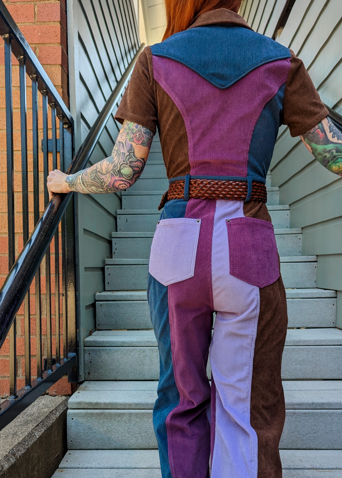 70s inspired stretch Dusk Patchwork Mustang Corduroy Jumpsuit with zip front and collared neckline in purple, blue, and brown by Nine Lives Bazaaar