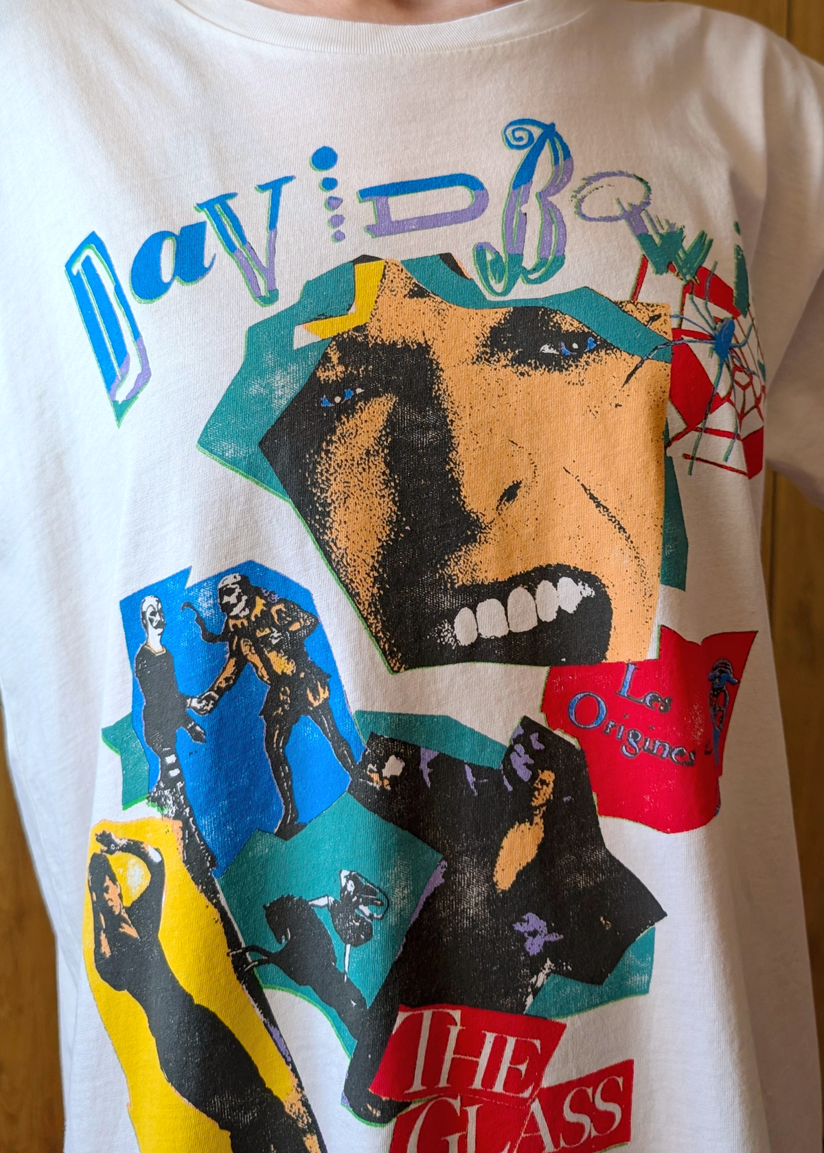 T-shirt with colorful graphic design featuring David Bowie graphics on a white background