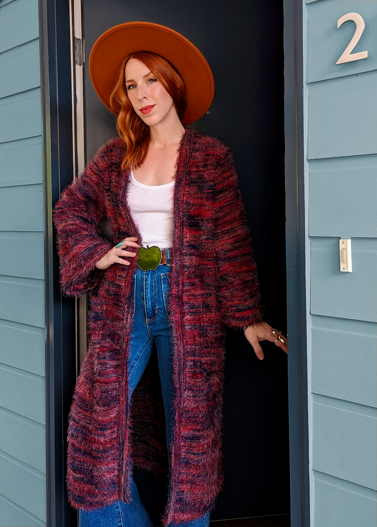 70s inspired fuzzy eyelash knit cardigan duster with a midi-maxi length. Features an open front, wide bell cuffed sleeves, and a pink, red, and purple spacedye design