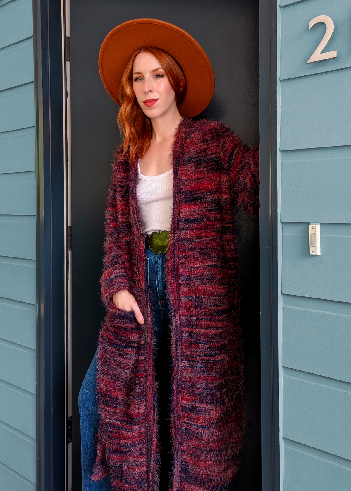 70s inspired fuzzy eyelash knit cardigan duster with a midi-maxi length. Features an open front, wide bell cuffed sleeves, and a pink, red, and purple spacedye design