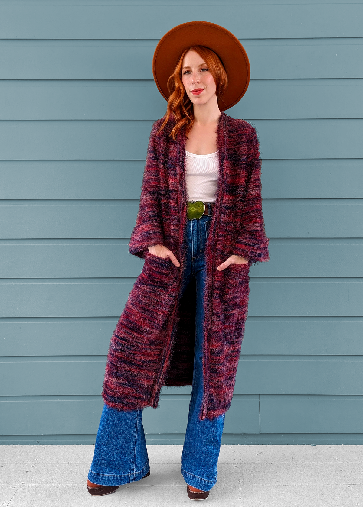 70s inspired fuzzy eyelash knit cardigan duster with a midi-maxi length. Features an open front, wide bell cuffed sleeves, and a pink, red, and purple spacedye design