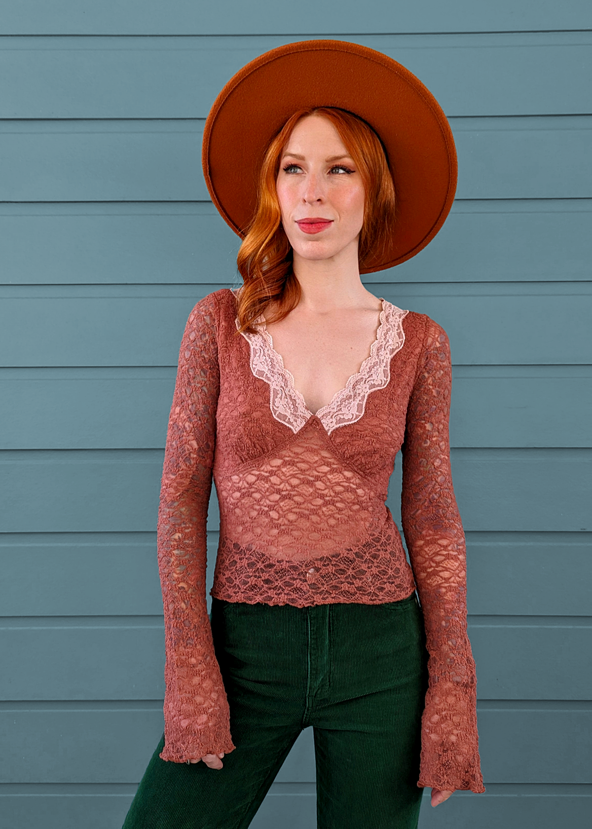 90s inspired withered rose netted lace top with deep v neckline accented with pale pink lace trim. Long fluted sleeves. Fully lined at bust, unlined through the rest. By Motel Rocks.