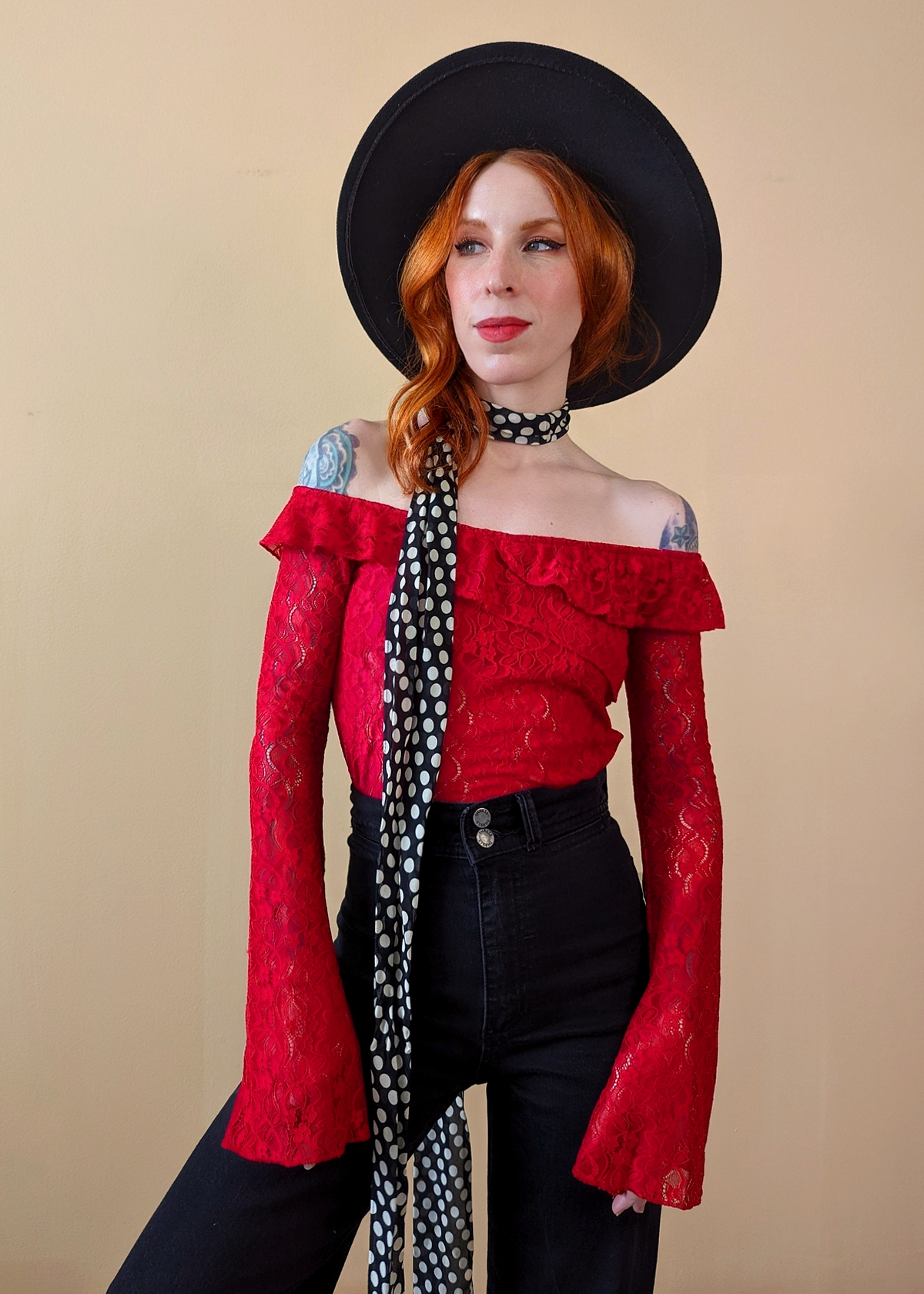 80s inspired lipstick red floral lace top with bardot off shoulder neckline, ruffle details, and long fluted bell sleeves. By Motel Rocks