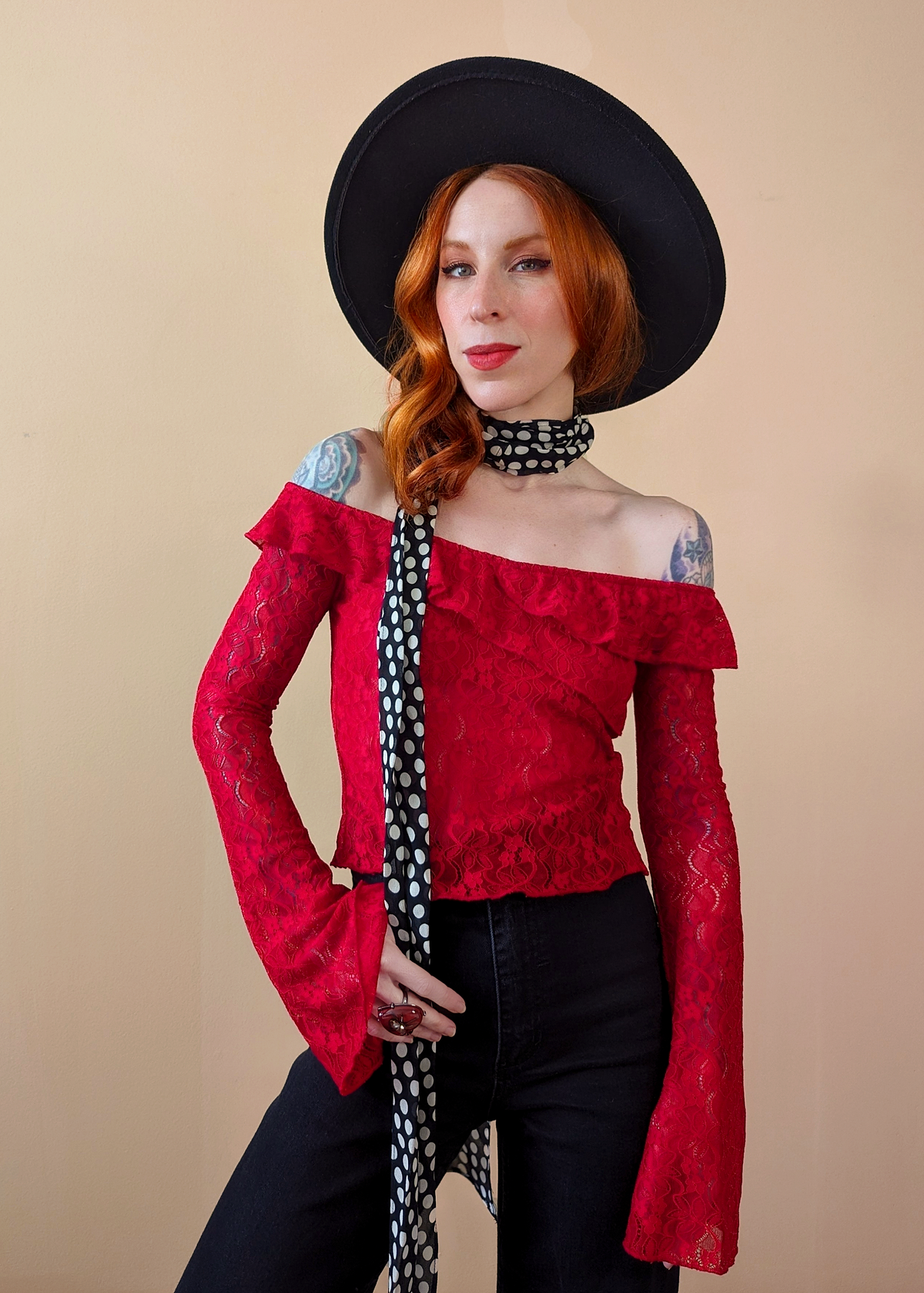 80s inspired lipstick red floral lace top with bardot off shoulder neckline, ruffle details, and long fluted bell sleeves. By Motel Rocks