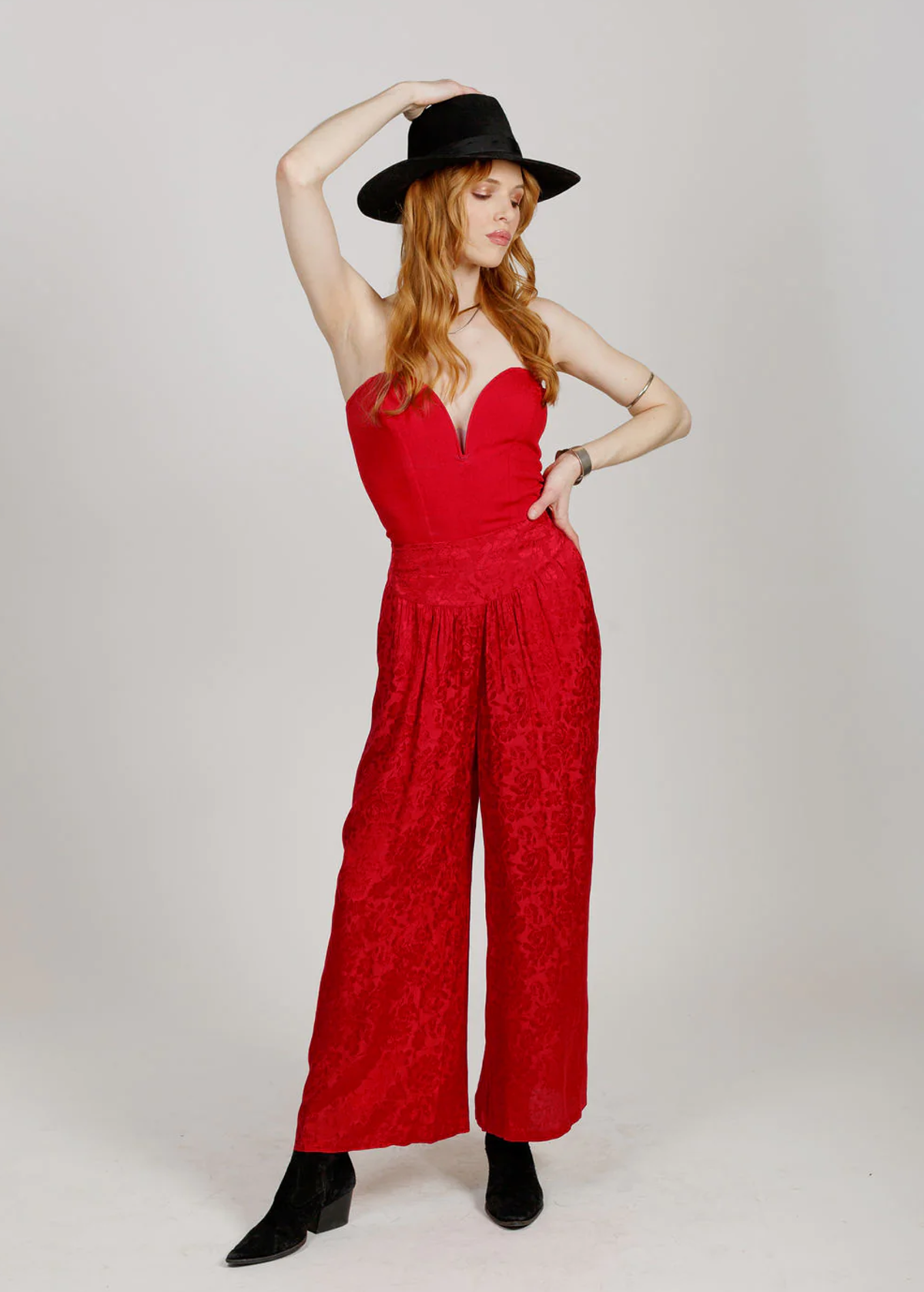 80s inspired ruby red satin wide leg pants with a wide waistband, elastic back of waist, and tonal floral pattern throughout