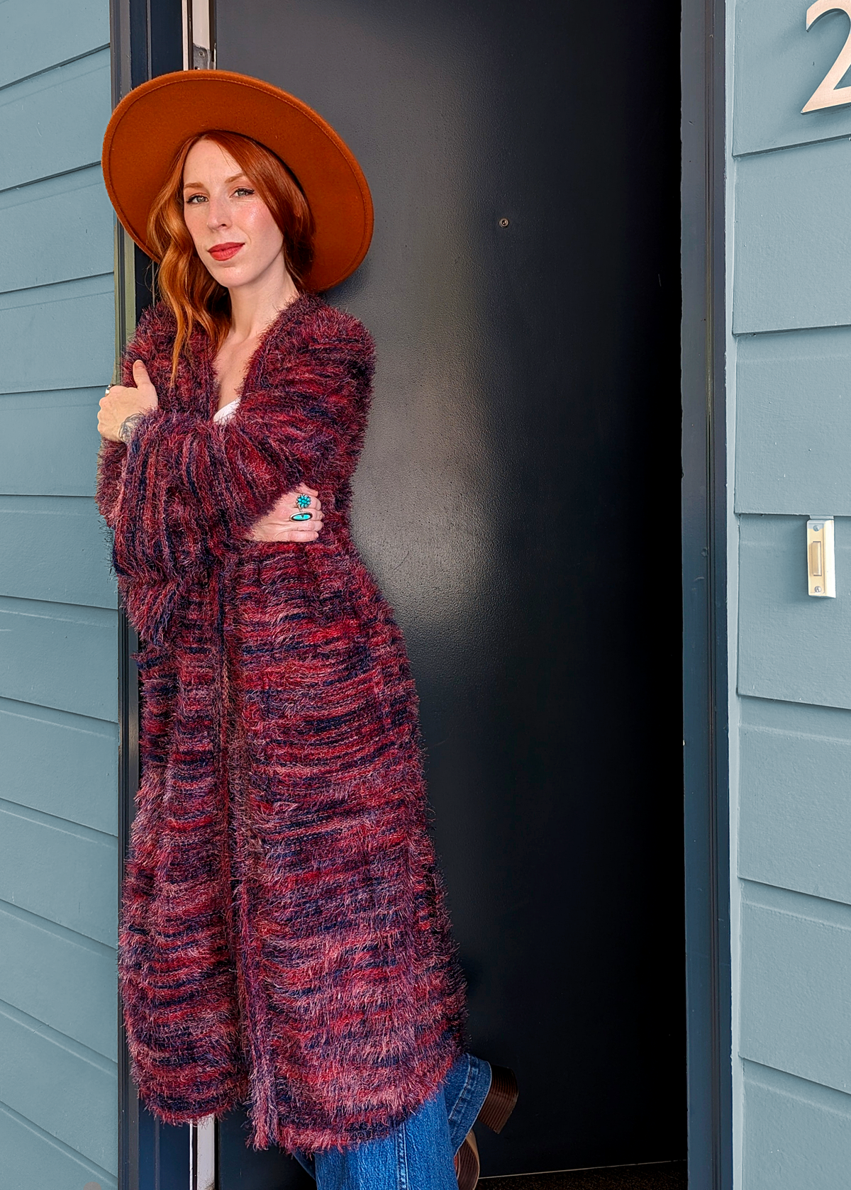 70s inspired fuzzy eyelash knit cardigan duster with a midi-maxi length. Features an open front, wide bell cuffed sleeves, and a pink, red, and purple spacedye design