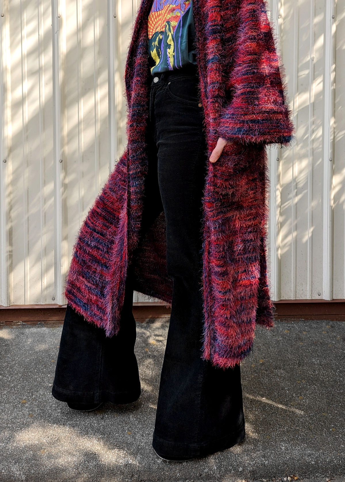 70s inspired fuzzy eyelash knit cardigan duster with a midi-maxi length. Features an open front, wide bell cuffed sleeves, and a pink, red, and purple spacedye design