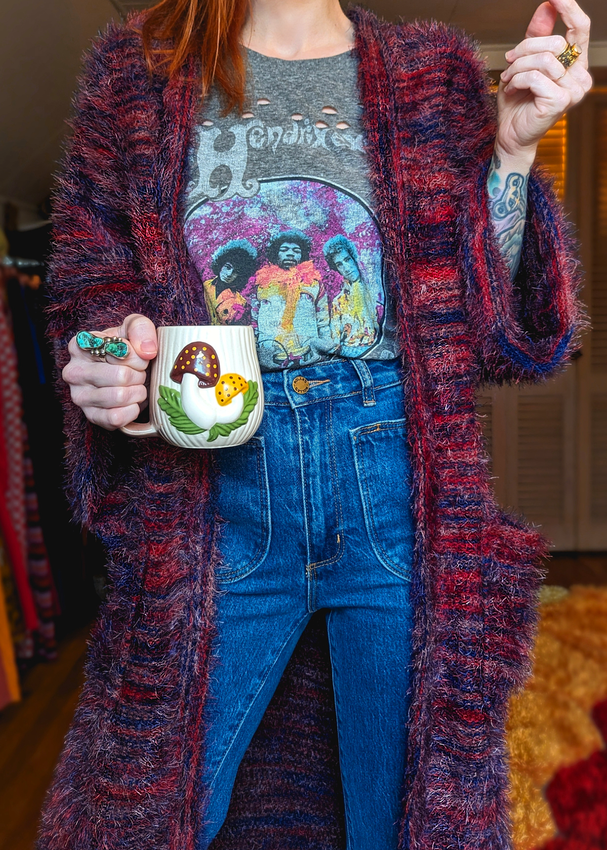 70s inspired fuzzy eyelash knit cardigan duster with a midi-maxi length. Features an open front, wide bell cuffed sleeves, and a pink, red, and purple spacedye design