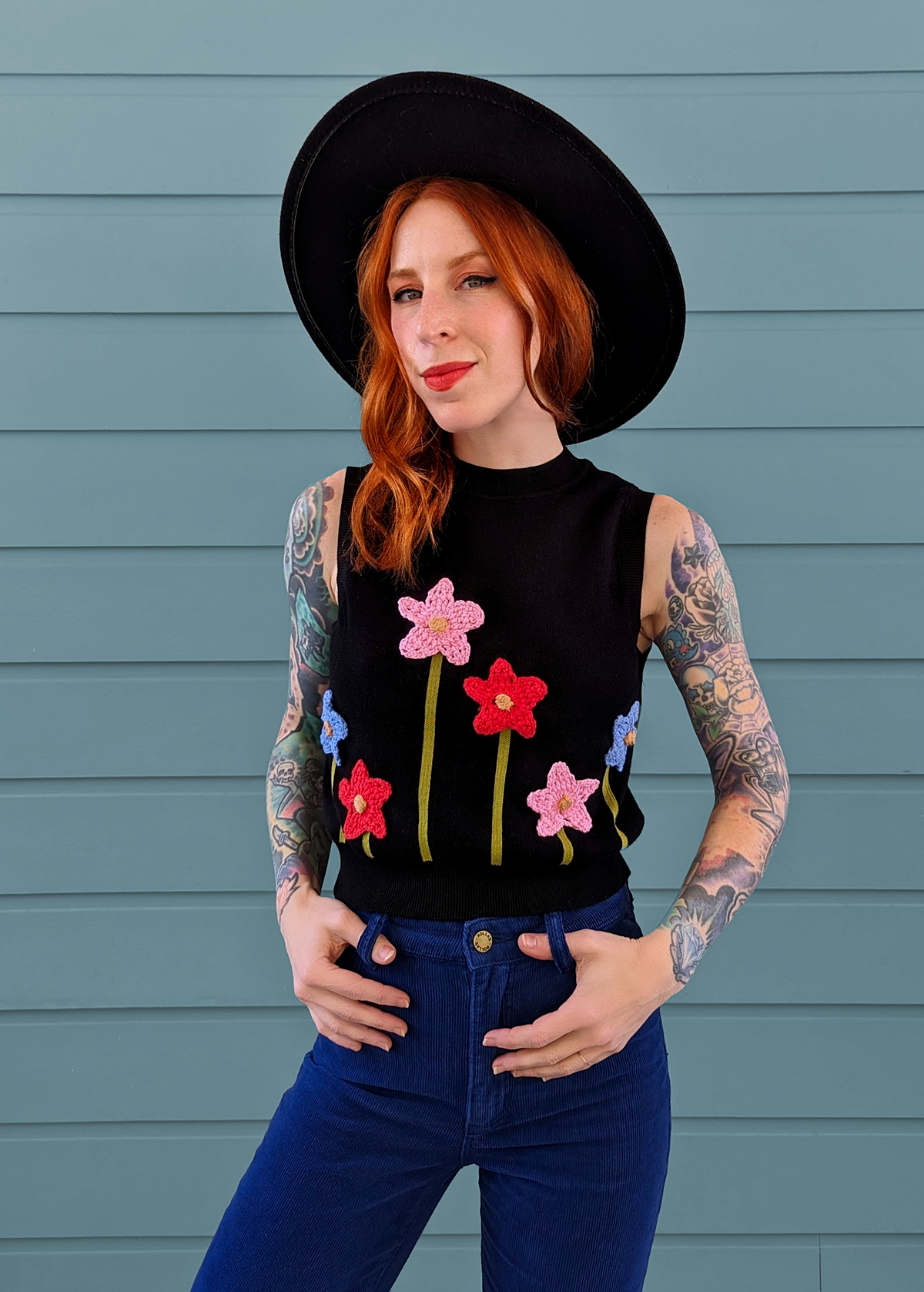 Black Organic Cotton Knit Sweater Vest with colorful crochet flowers at front, by Another Girl, sustainable and ethically made