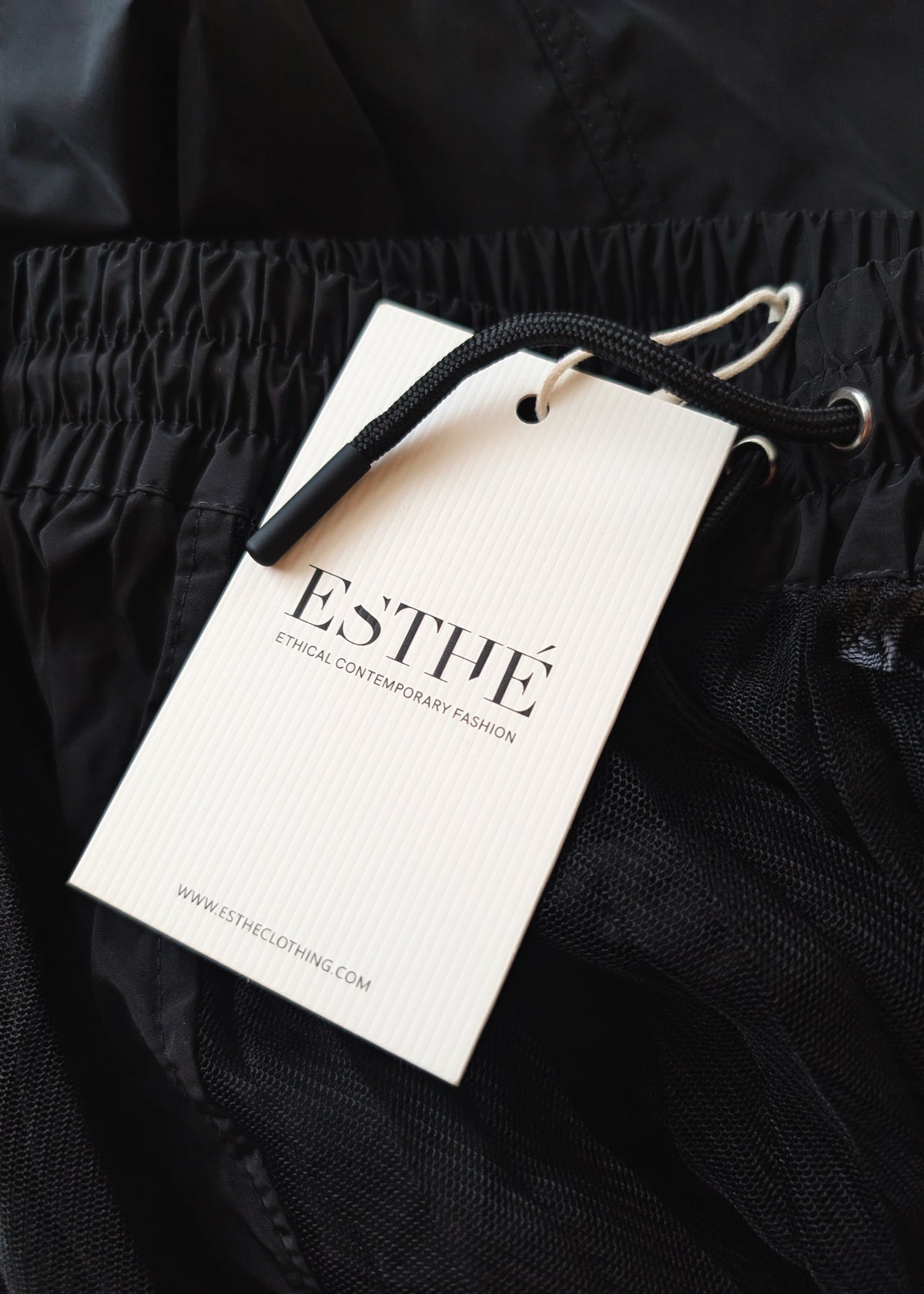 details of the black cargo skirt with 'ESTHE' hang tag