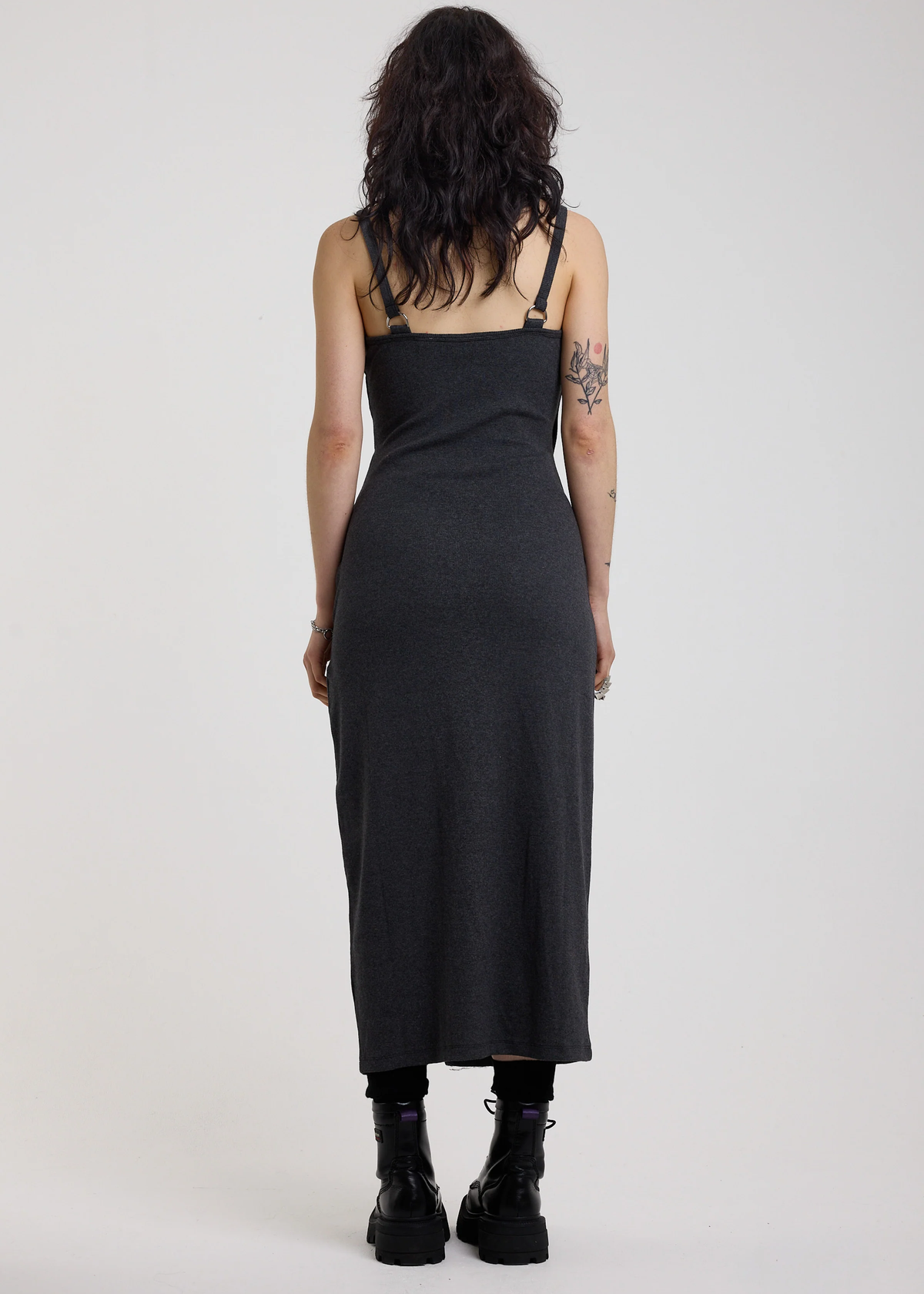 Person wearing a charcoal grey ribbed tank midi dress with straps on a white background