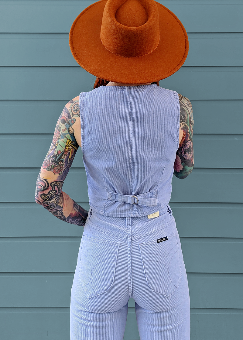 Rolla's Jeans Wisteria Blue Corduroy Dallas Vest. 70s inspired and features a v-neckline, button front, and adjustable buckle at back.