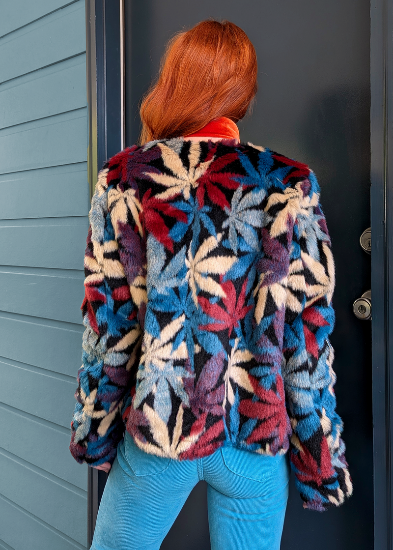 70s inspired faux fur jacket coat with colorful pot leaf design allover in teal, blue, maroon, purple, beige, and black. Open front with a collarless style. 