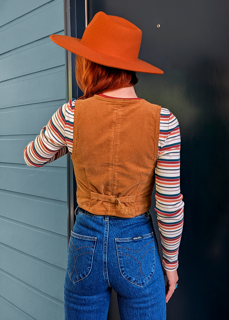 Rolla's Jeans Tan Corduroy Dallas Vest. 70s inspired vest featuring a v-neckline, button front, and adjustable buckle back. 