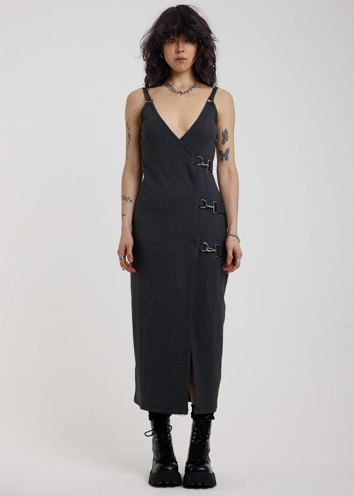 Person wearing a charcoal grey ribbed tank dress with a white background