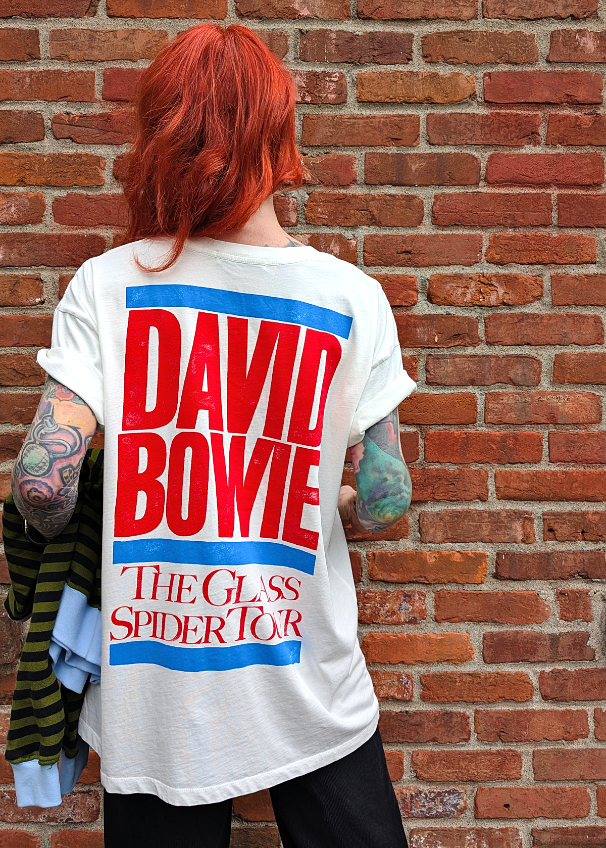Slouchy, oversized fit white tee with colorful David Bowie The Glass Spider Tour graphics in large font at back in red and blue. Made in the USA and officially licensed