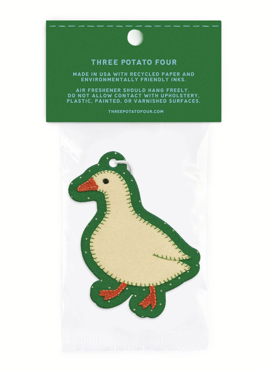 Green and beige goose-shaped air freshener on a white background with a green label.