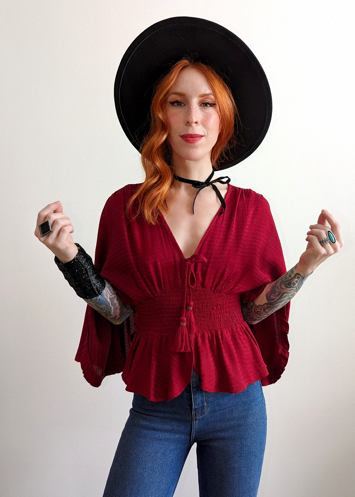 Stevie Nicks Vibes. Deep red top with batwing cape sleeves, smocked bodice, and tassel tie details at front