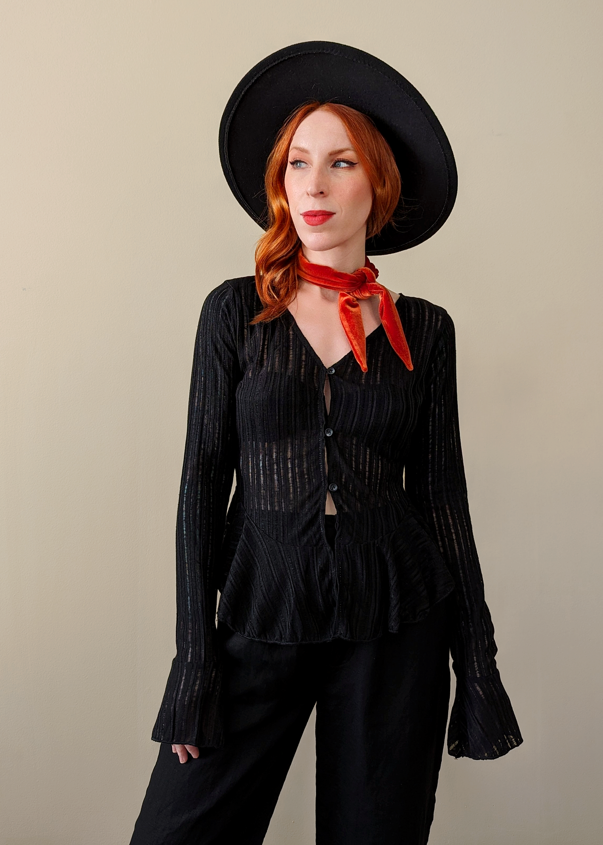 Motel Rocks Black Sheer Woven Knit Cardigan with a deep v neckline, button front, and fluted bell sleeves