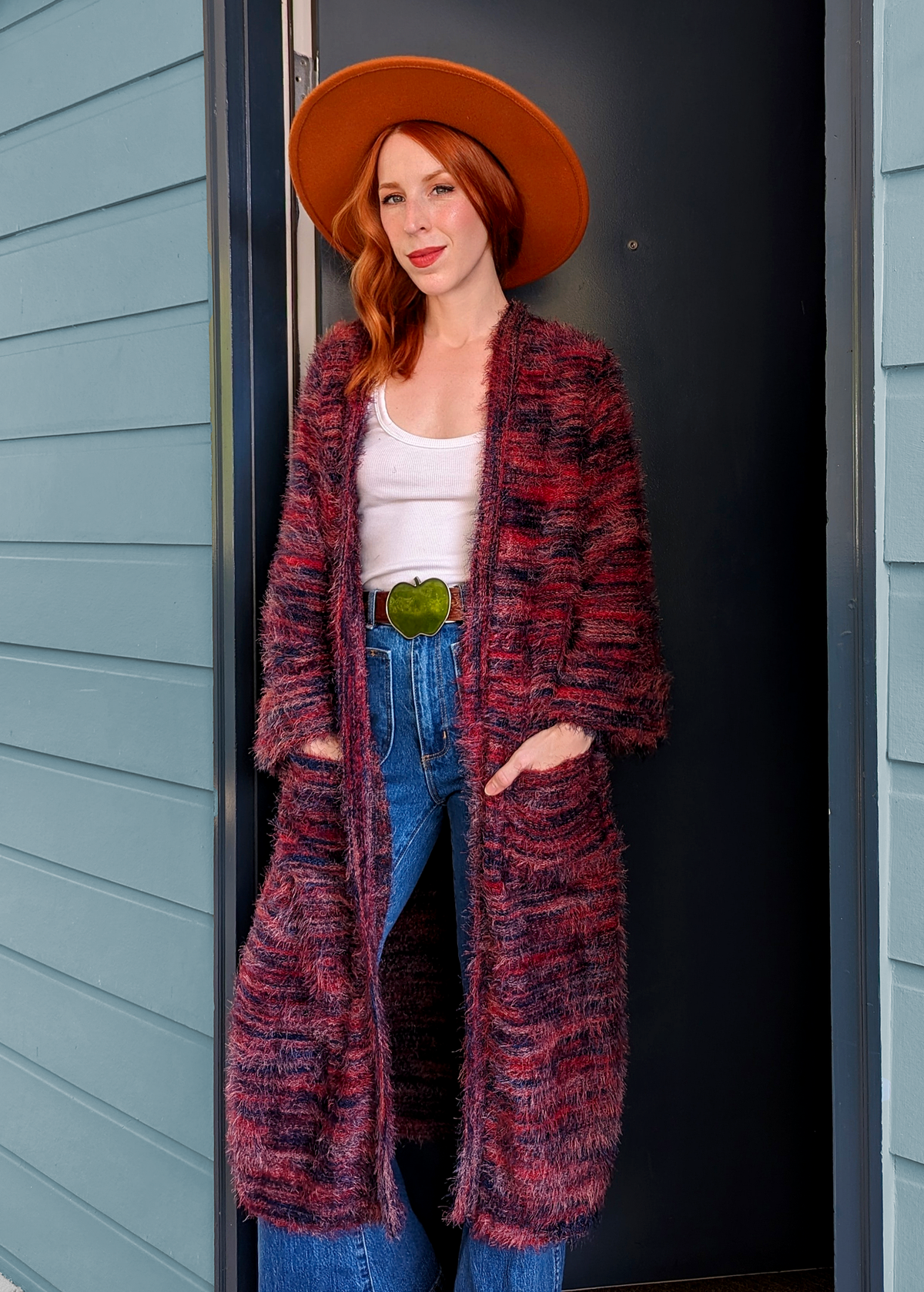 70s inspired fuzzy eyelash knit cardigan duster with a midi-maxi length. Features an open front, wide bell cuffed sleeves, and a pink, red, and purple spacedye design