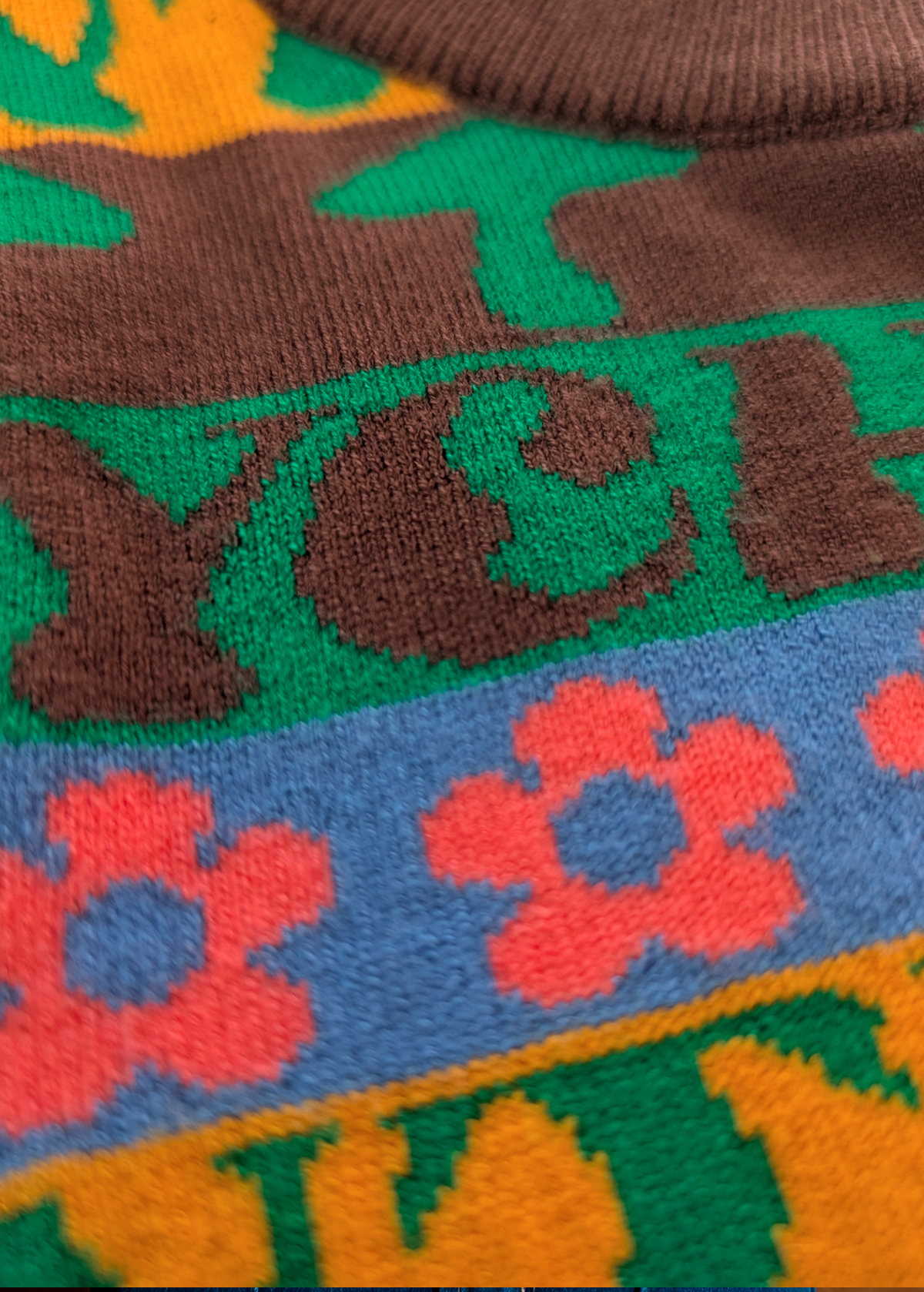 Close-up of a colorful fabric with floral patterns  and green mushrooms 