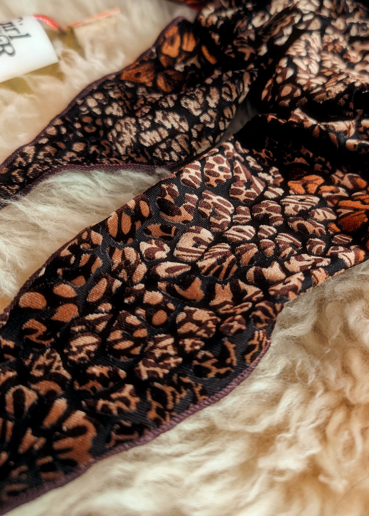 close up details of the animal print brown, black, and copper burnout velvet scarf