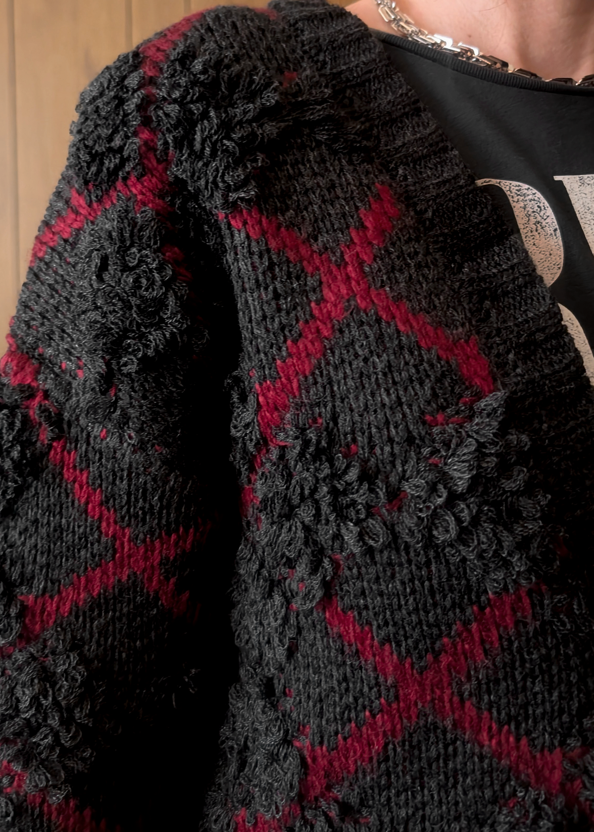 Close-up of a charcoal  and red patterned garment with a blurred background