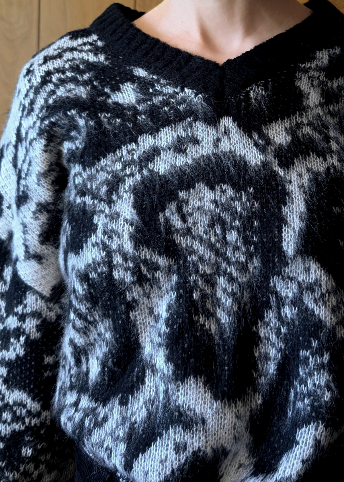 Close-up of a black and gray patterned sweater