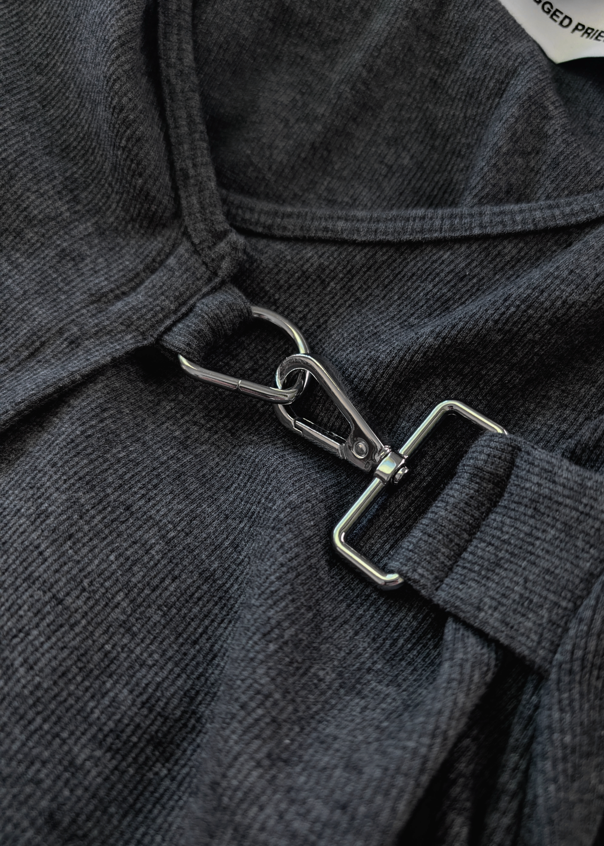 Details of the ribbed charcoal grey fabric and silver buckle detail
