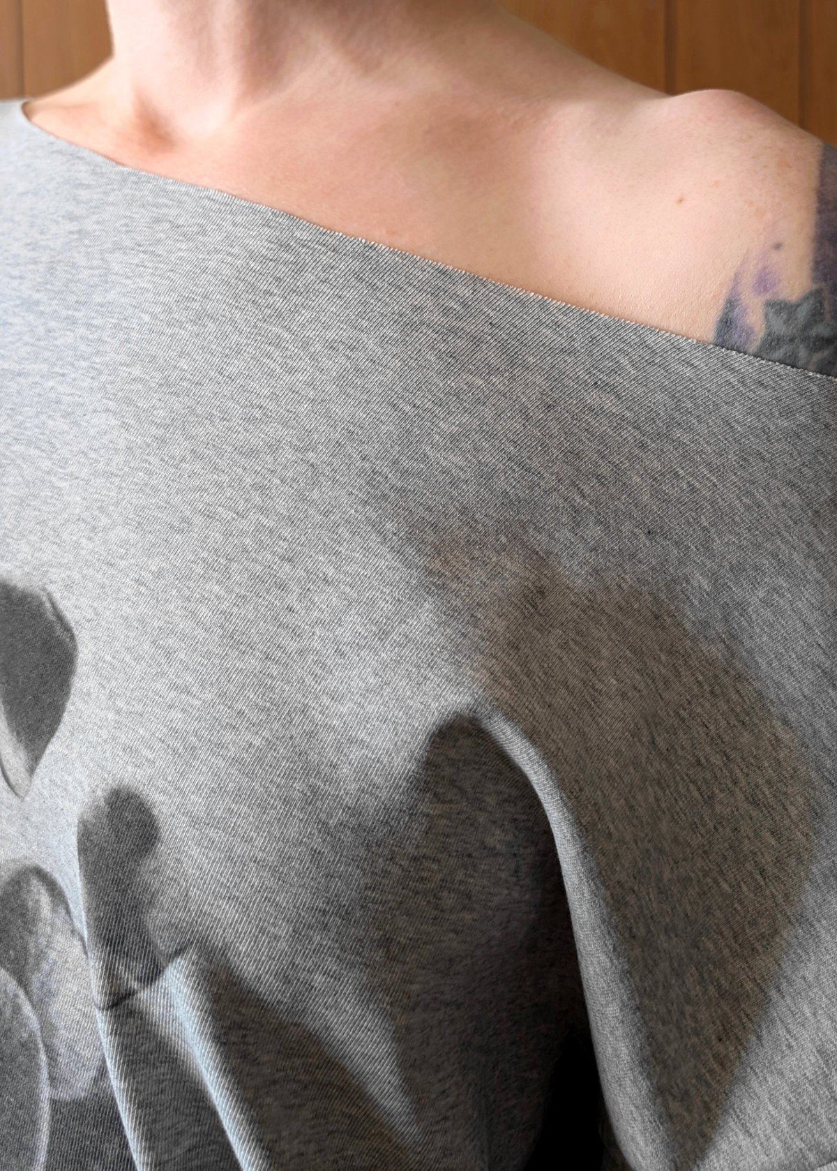 details of fabric and raw cut neckline 