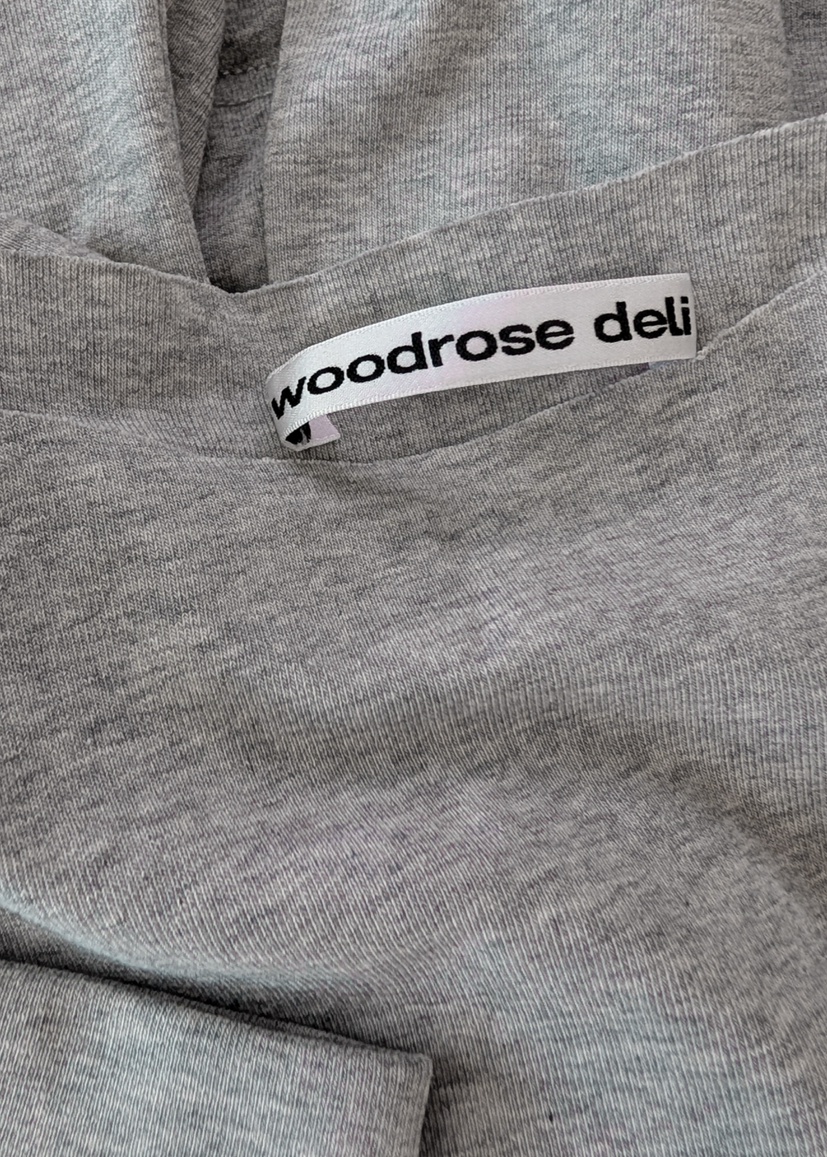 details of the Gray jersey fabric with a 'woodrose deli' label