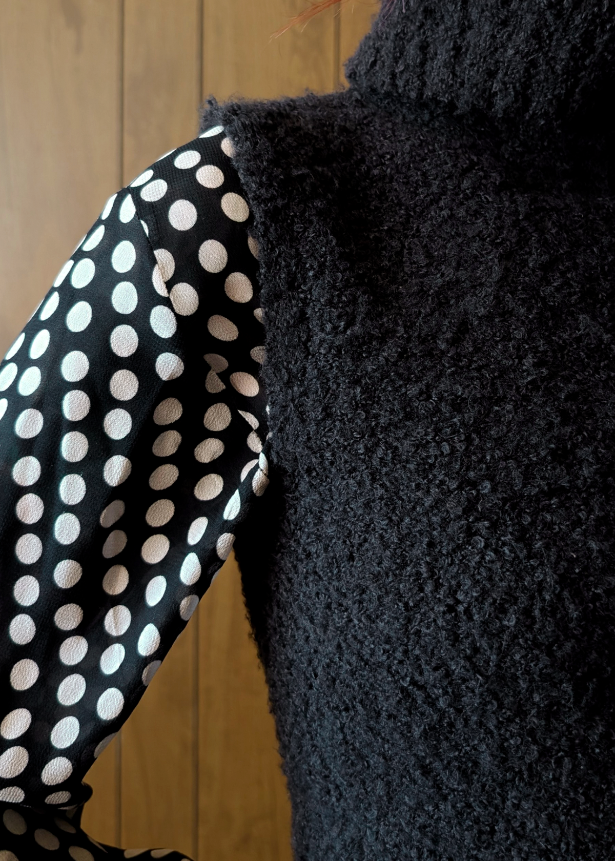 Close-up of a black textured fabric aagainst a wooden background