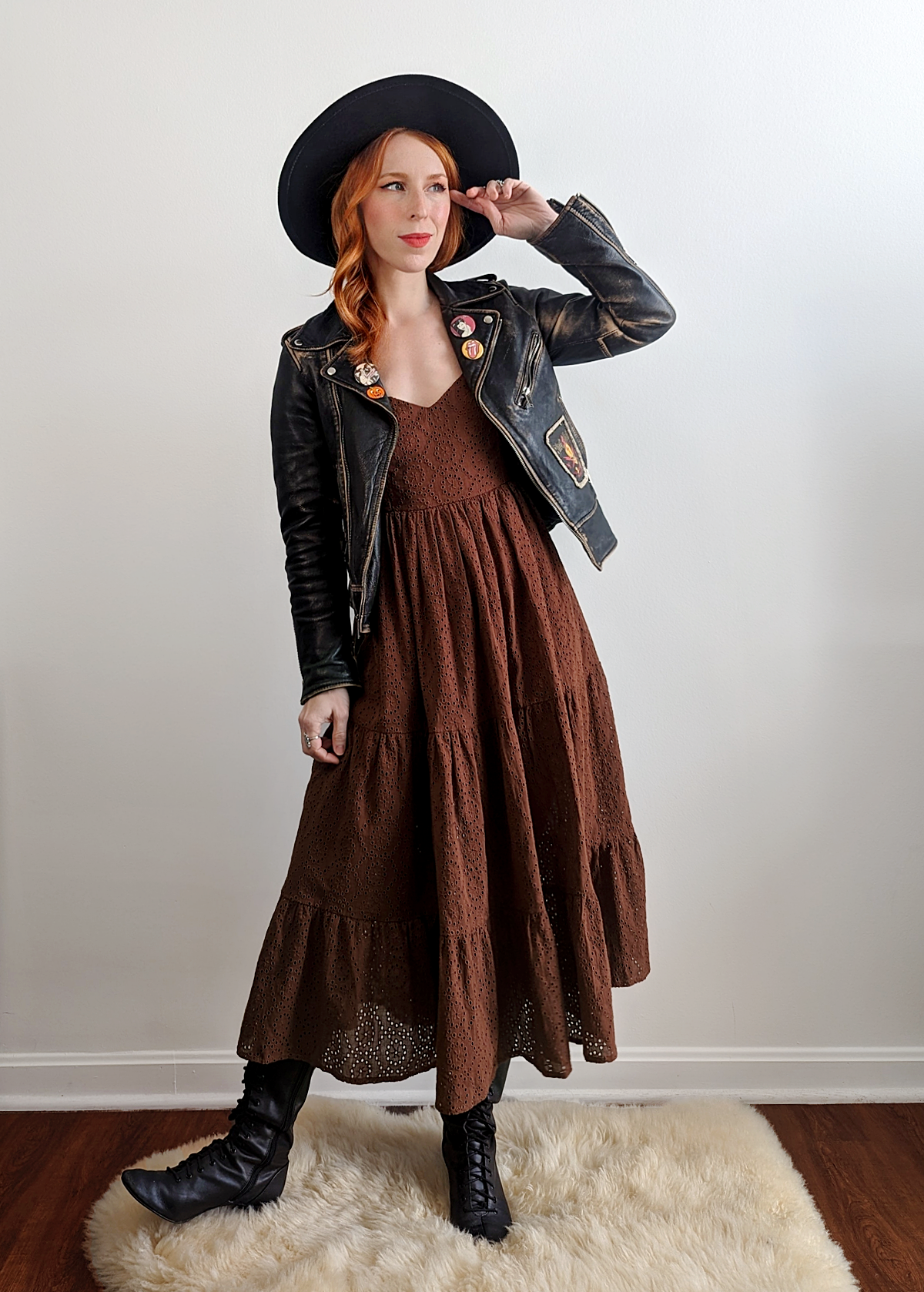 70s inspired prairie dress made of 100% eyelet cotton in a walnut brown colorway. Features puff sleeves, sweetheart neckline, smocked back with tie closure, and ruffled tiered skirt. 