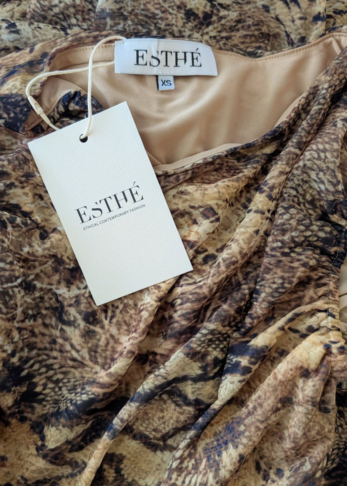Snakeskin patterned fabric with ESTHE tag 