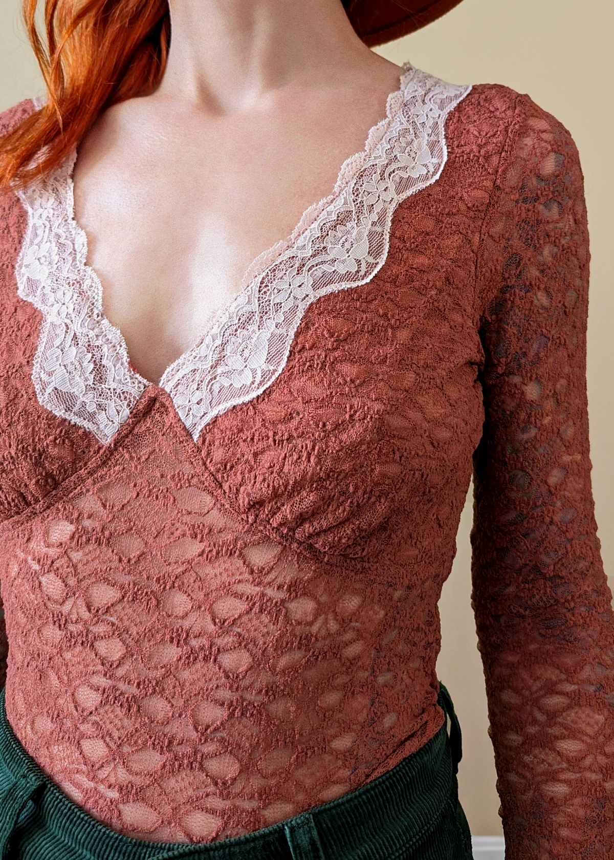 90s inspired withered rose netted lace top with deep v neckline accented with pale pink lace trim. Long fluted sleeves. Fully lined at bust, unlined through the rest. By Motel Rocks.