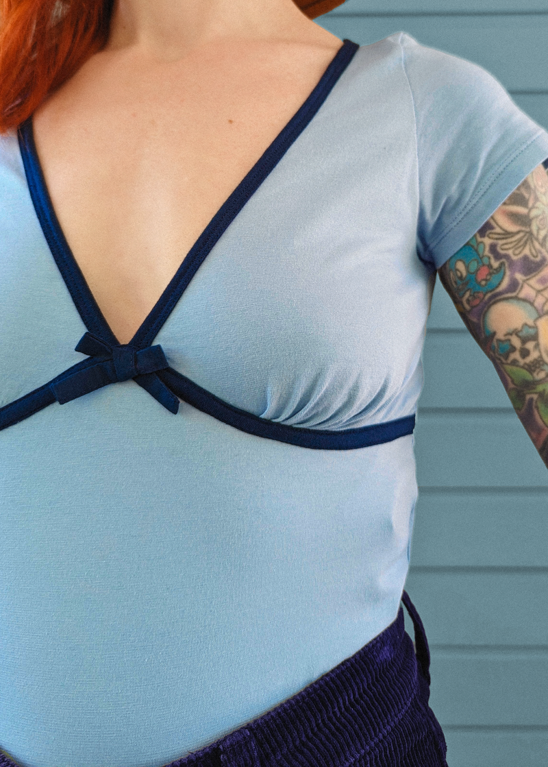 Baby Blue top with navy binding and bow by Motel Rocks