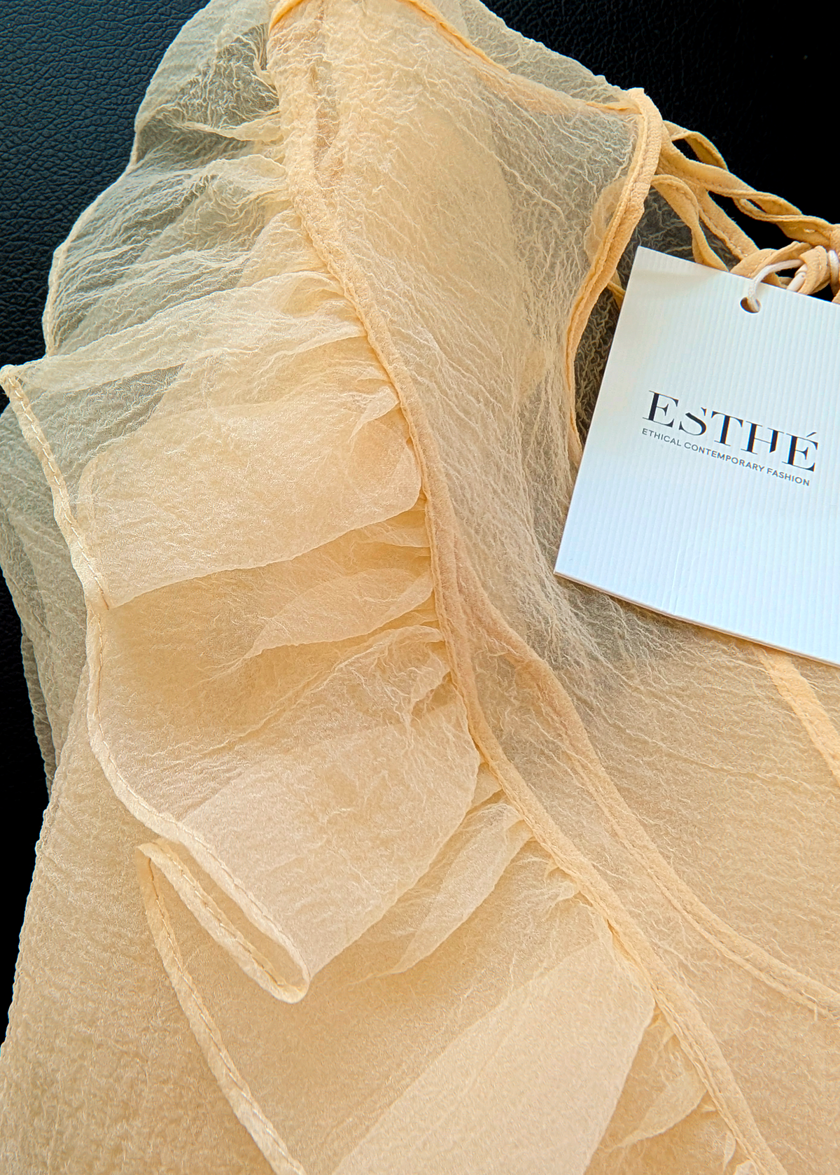 close up detail of the yellow organza top with brand's hangtag