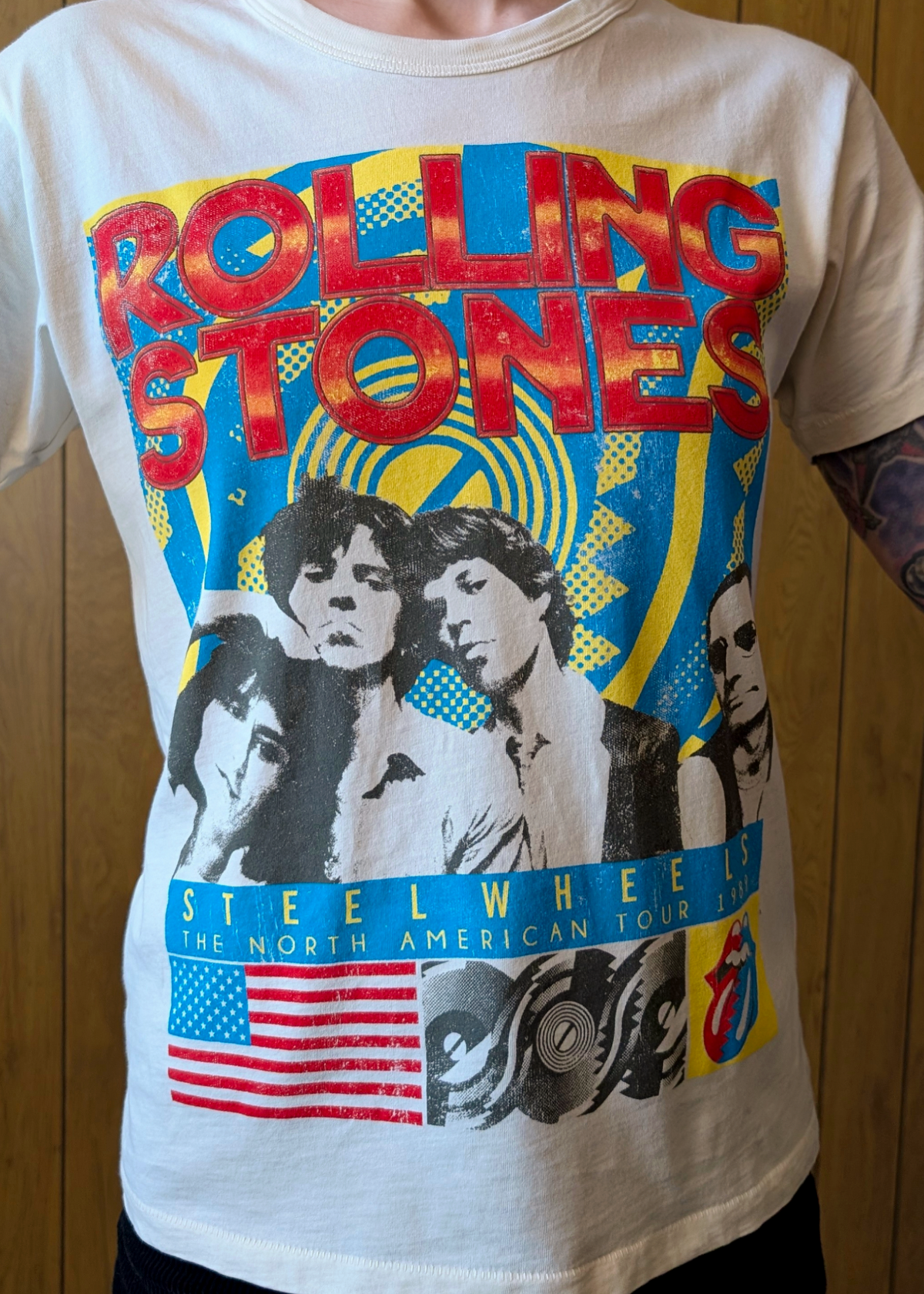 Ivory t-shirt with Rolling Stones graphic design on a wooden background