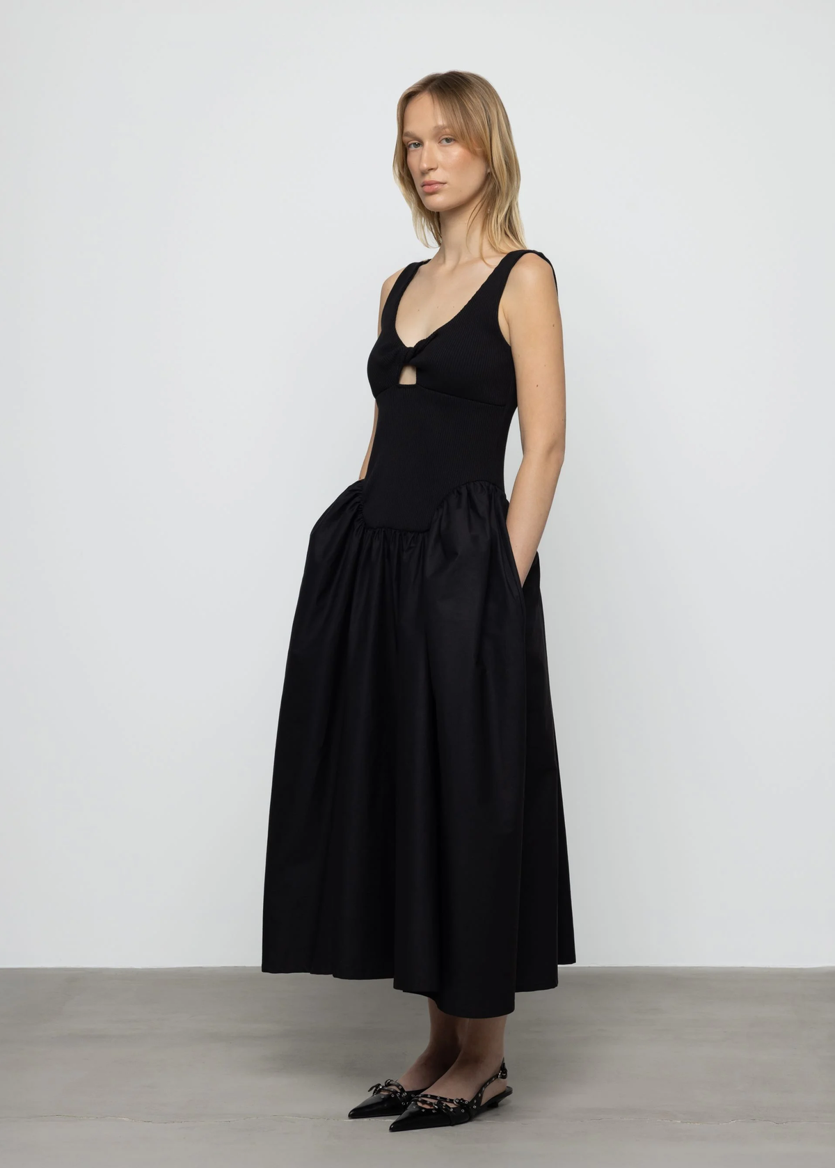 Woman wearing a black dress against a white background