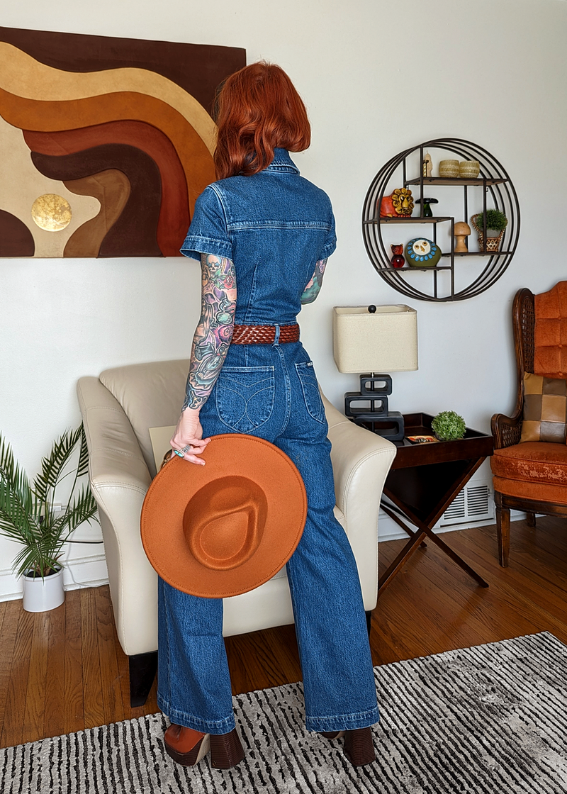 Rolla's Jeans retro 70s inspired blue denim jumpsuit featuring a collared neckline, button front, patch sailor pockets at front, and a wide sailor leg with a cropped ankle length.