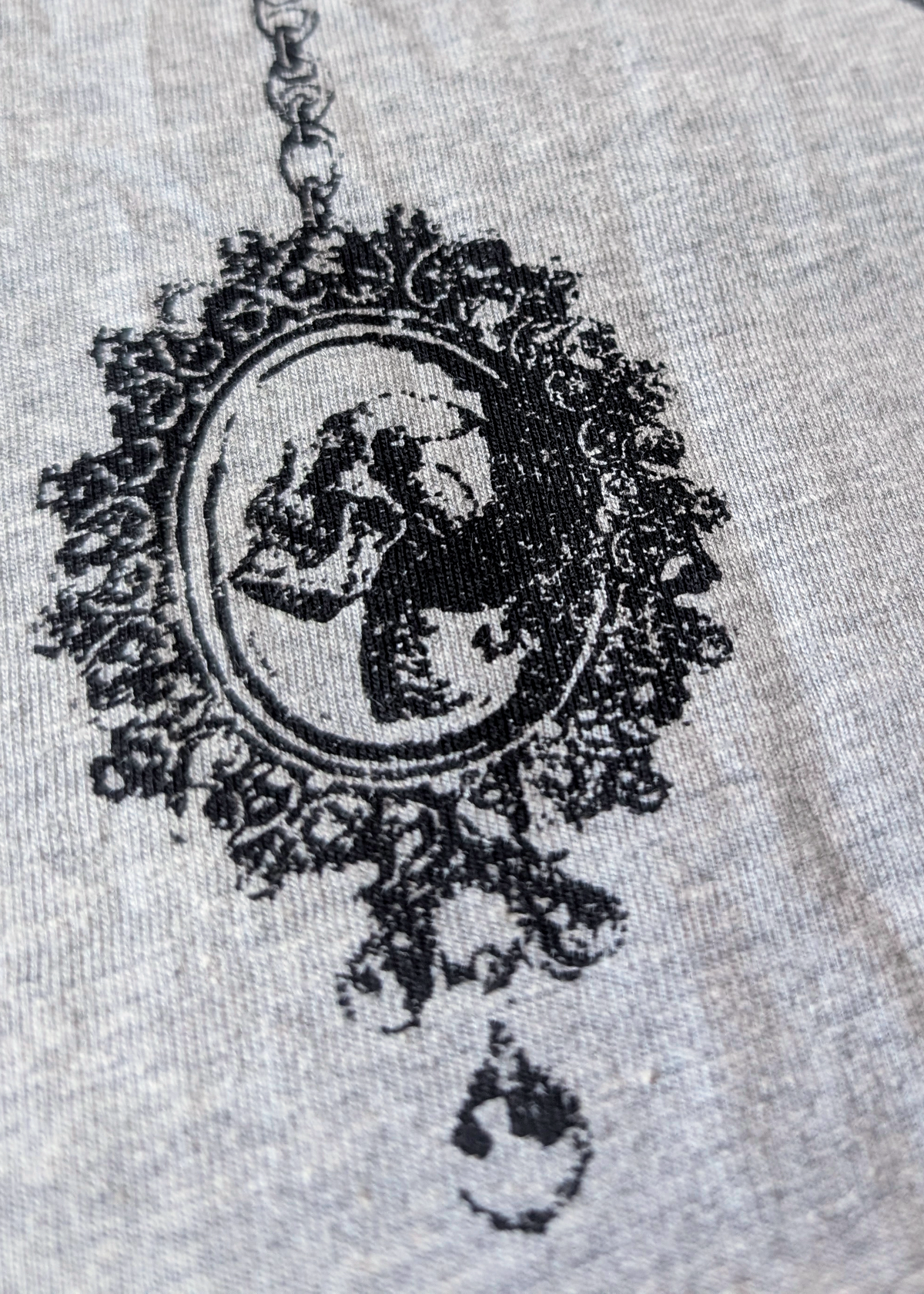 Black lace and skull cameo graphic design on the grey tee