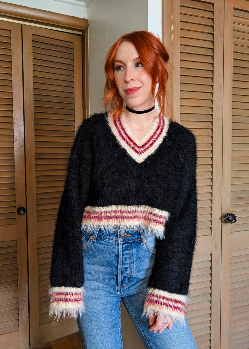 '90s inspired fluffy v-neck varsity crop length Snitch sweater by Ragged Priest. Black with cream and burgundy red stripes. 