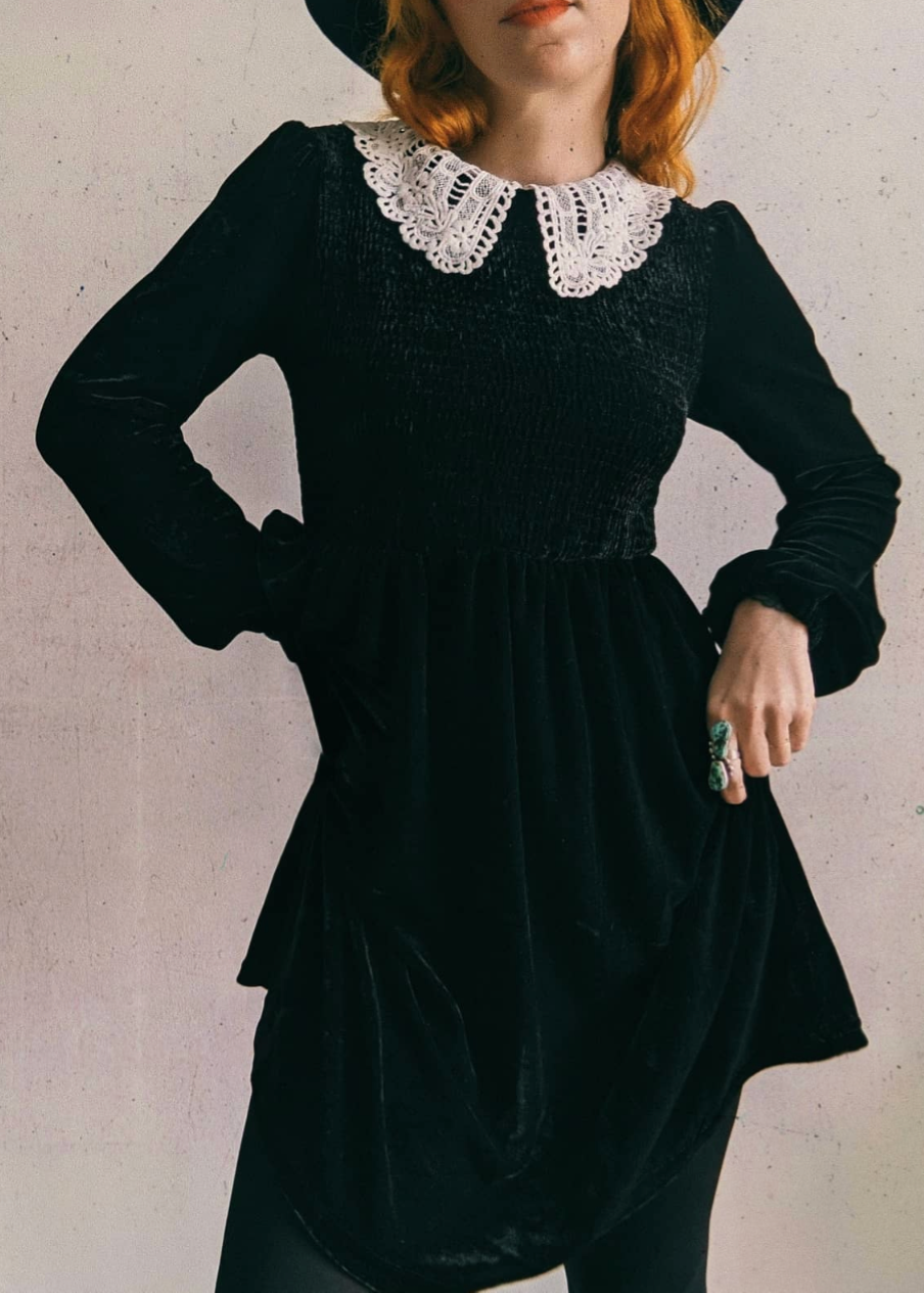 Daisy Street Wednesday Addams Doll Parts Black Velvet Babydoll Dress with smocked detailing and white lace collar. Giving 60s meets 90s vibes!