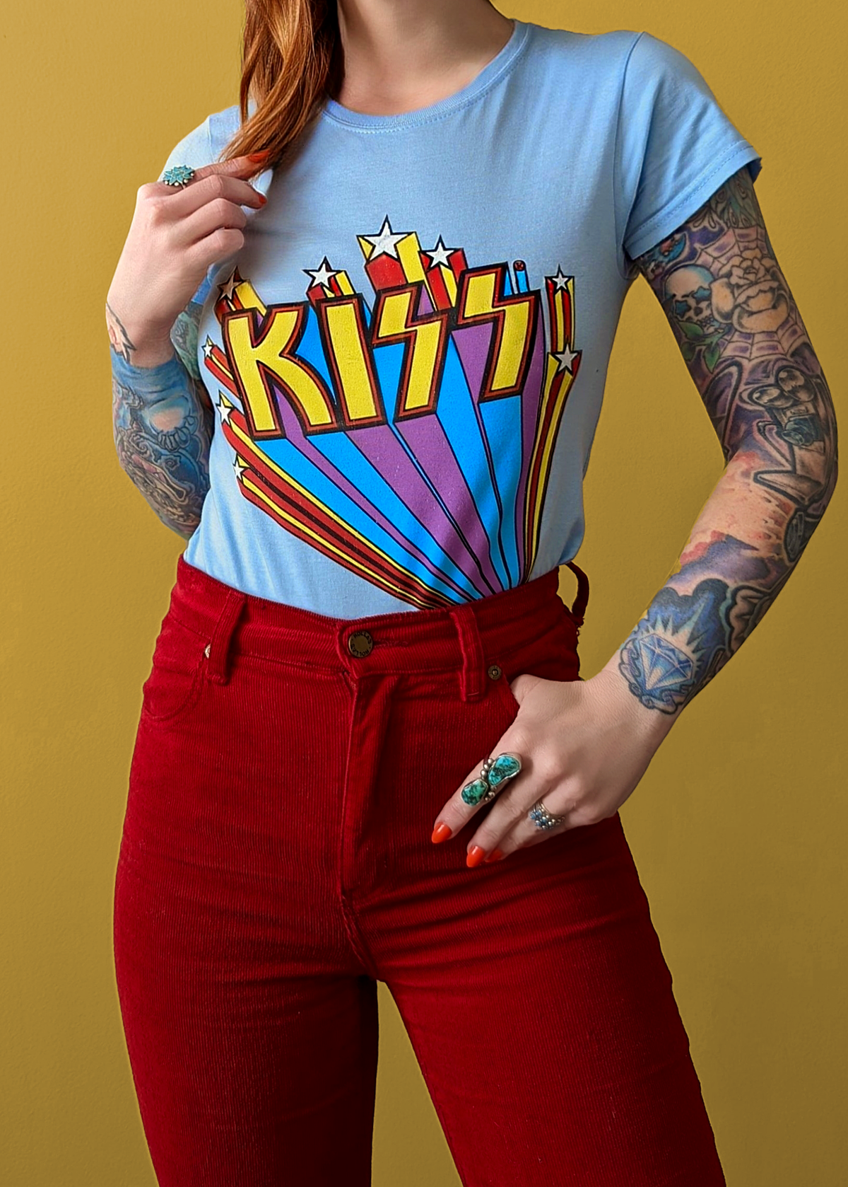 Retro Fitted sky blue KISS band tee with rainbow and stars design in yellow, purple, blue, and red. Officially licensed.